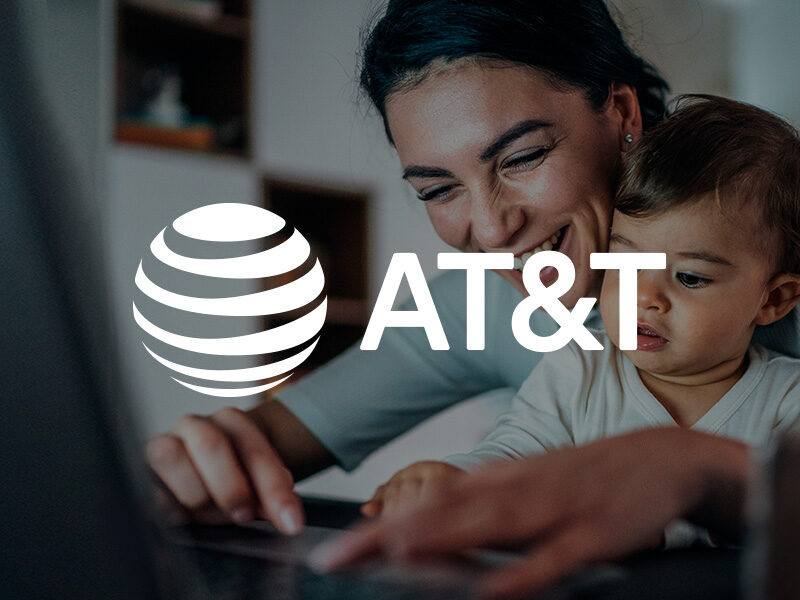 AT&T logo over an image of a mother and child working on a laptop computer.