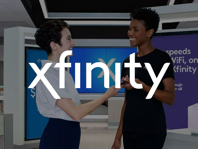 Xfinity logo over an image of two women standing inside a xfinity store.